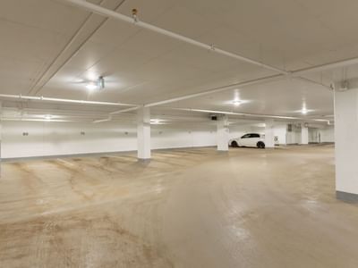 A well-lit underground parking garage with plenty of open spaces.