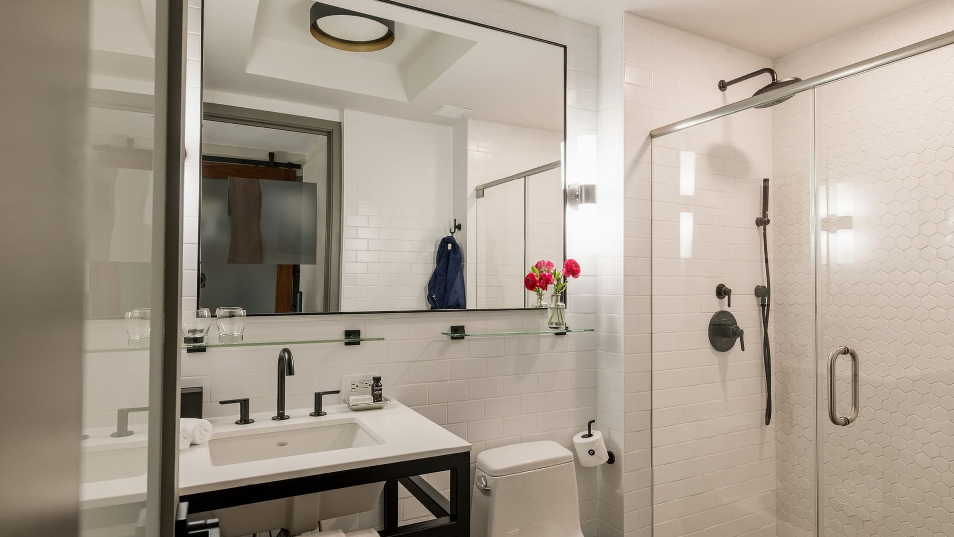 Terrace Room bathroom with white vanity and shower at Gansevoort Meatpacking NYC, among the top hotel rooms in Manhattan