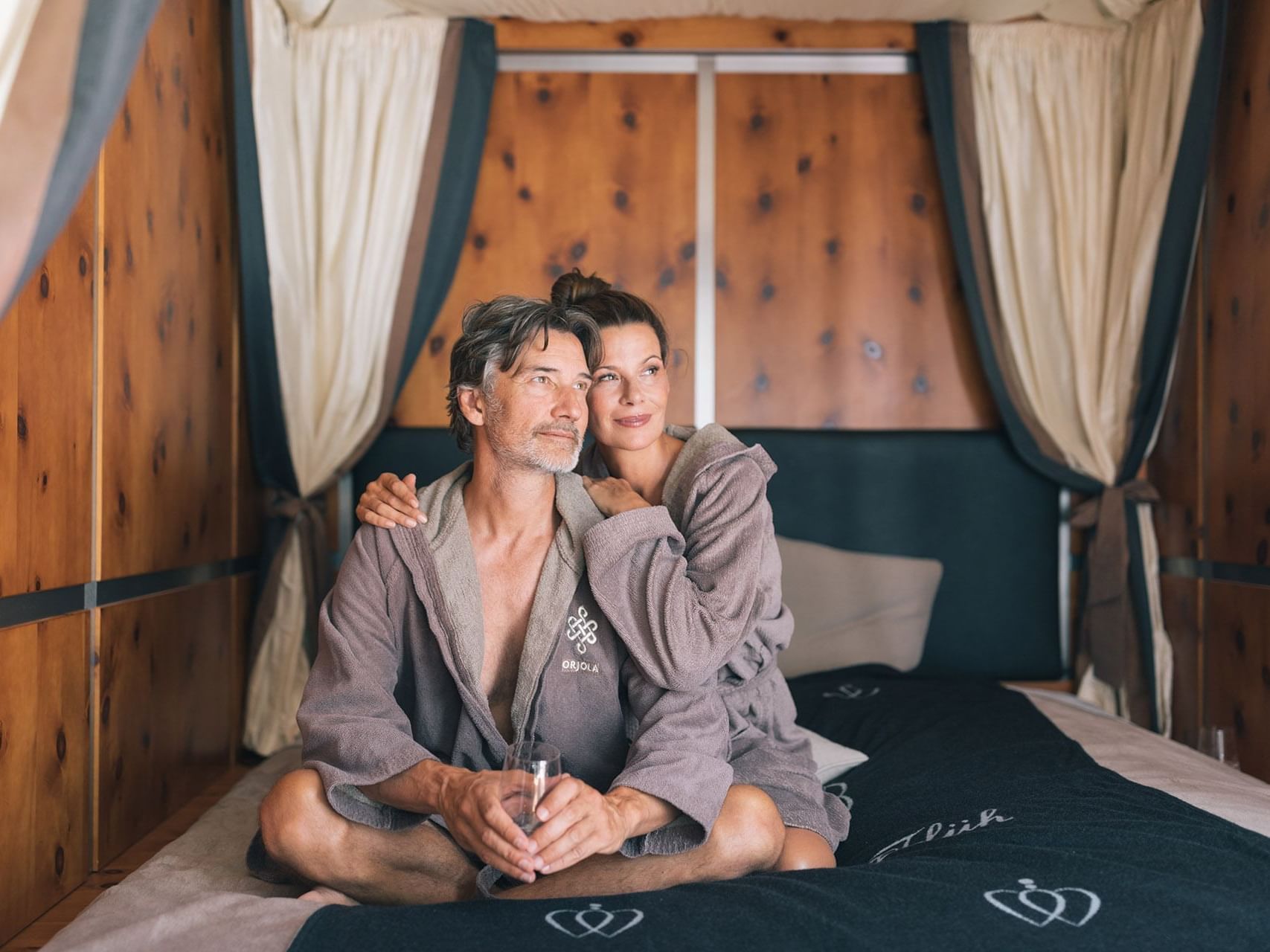 Portrait of a couple posing in robes at Liebes Rot Flueh