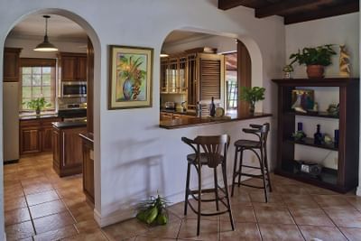 Seating area and kitchen within a Trinidad villa
