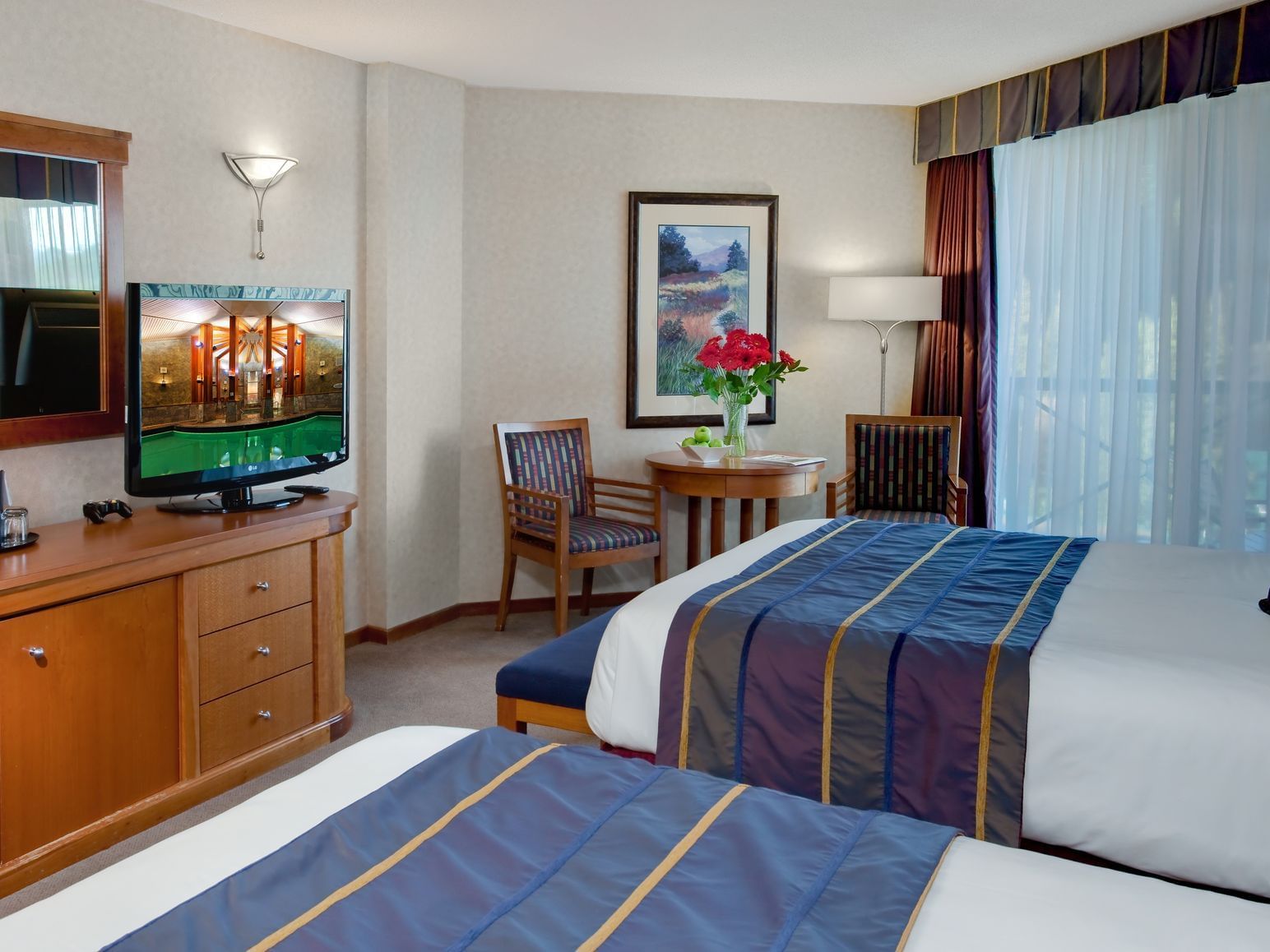 two beds in hotel room with window