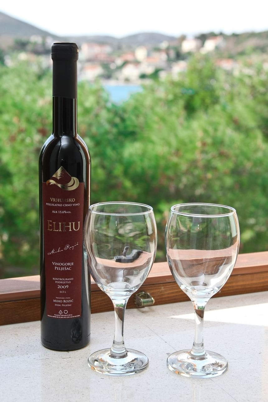 Wine bottle & glasses closeup at Pervanovo Vila Riva Apartments
