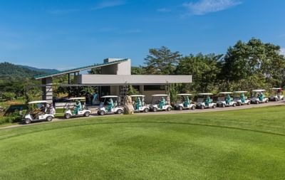 Golf carts with attendants at Chatrium Golf Resort's garden