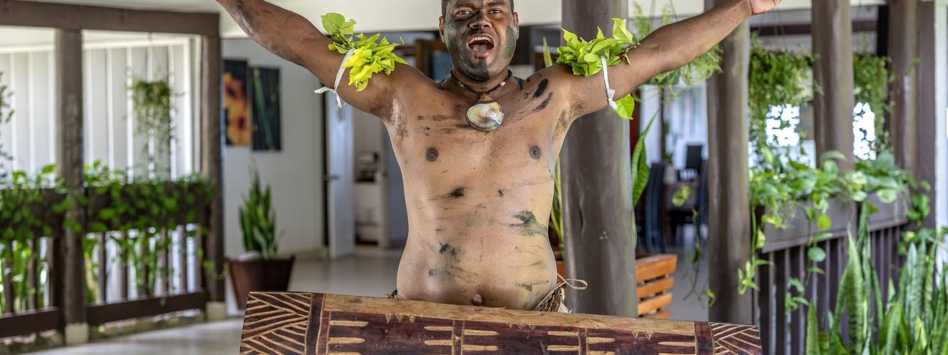 Local traditions performance with painted body and traditional attire at Tambua Sands Beach Resort in Sigatoka