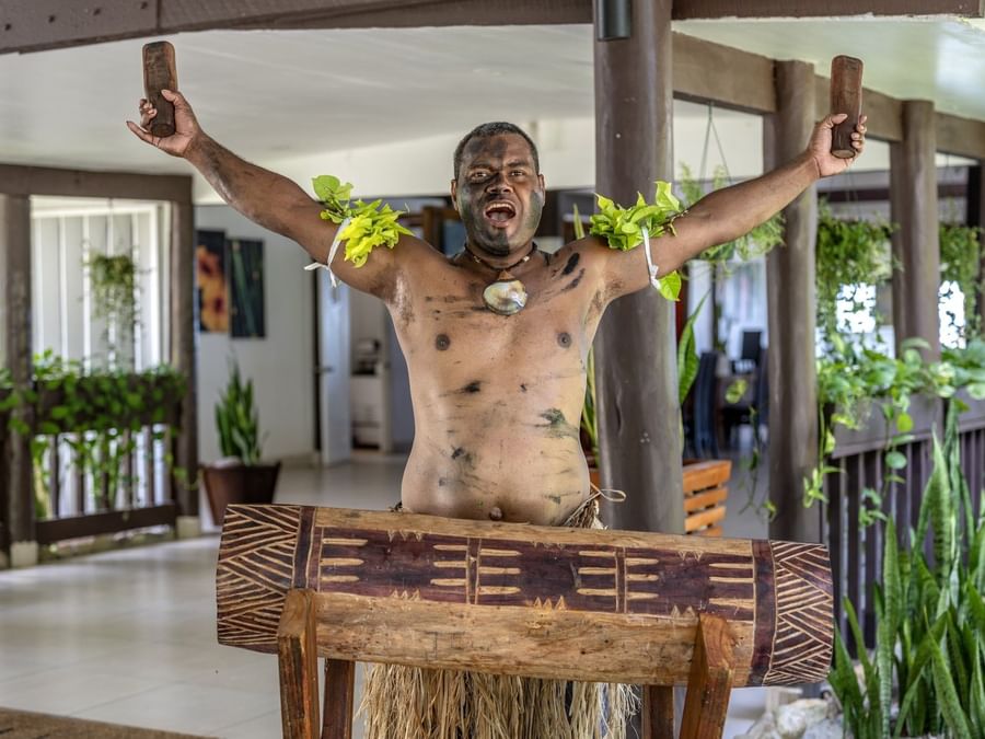 Local traditions performance with painted body and traditional attire at Tambua Sands Beach Resort in Sigatoka