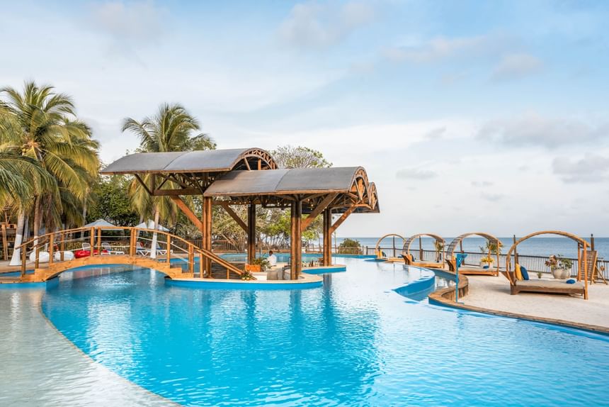 Outdoor swimming area with pool beds at Hotel Isla del Encanto