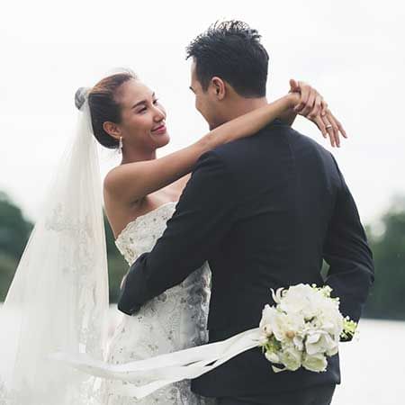 A woman wearing a wedding dress was hugging her husband - Lexis Suites Penang