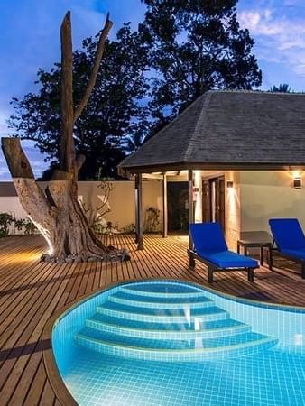 Poolside deck with blue lounge chairs and a private pool at Warwick Le Lagon - Vanuatu, Efate.