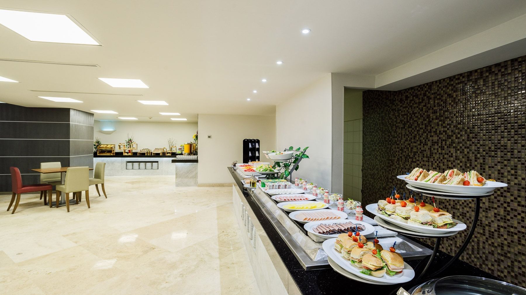 Stock Cafe Breakfast buffet featuring fresh sandwiches, deli meats, and salads at Real Inn Tijuana