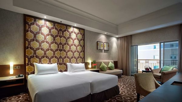 White bathrobe hanging on a rack with wooden hangers in Family Suite at Sunway Hotel Big Box