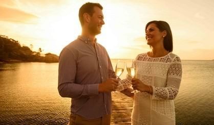 A couple toasting champagne glasses at Freycinet Lodge