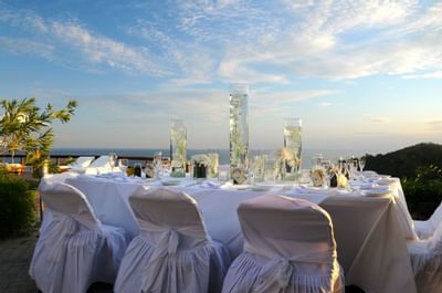 Dining area outdoors with a mountain view at Punta Islita Hotel