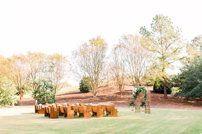 wedding venue in green field with woods in background