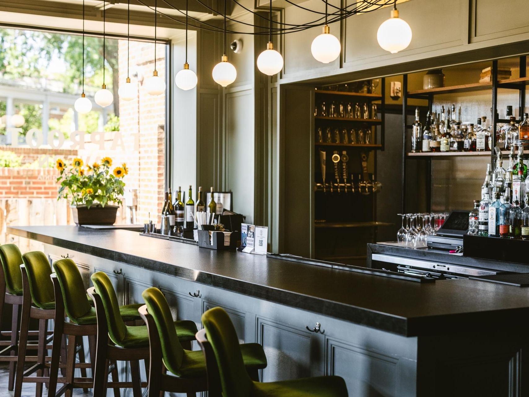 Bar shelves & bar stools in Taproot Tavern at Hotel Weyanoke