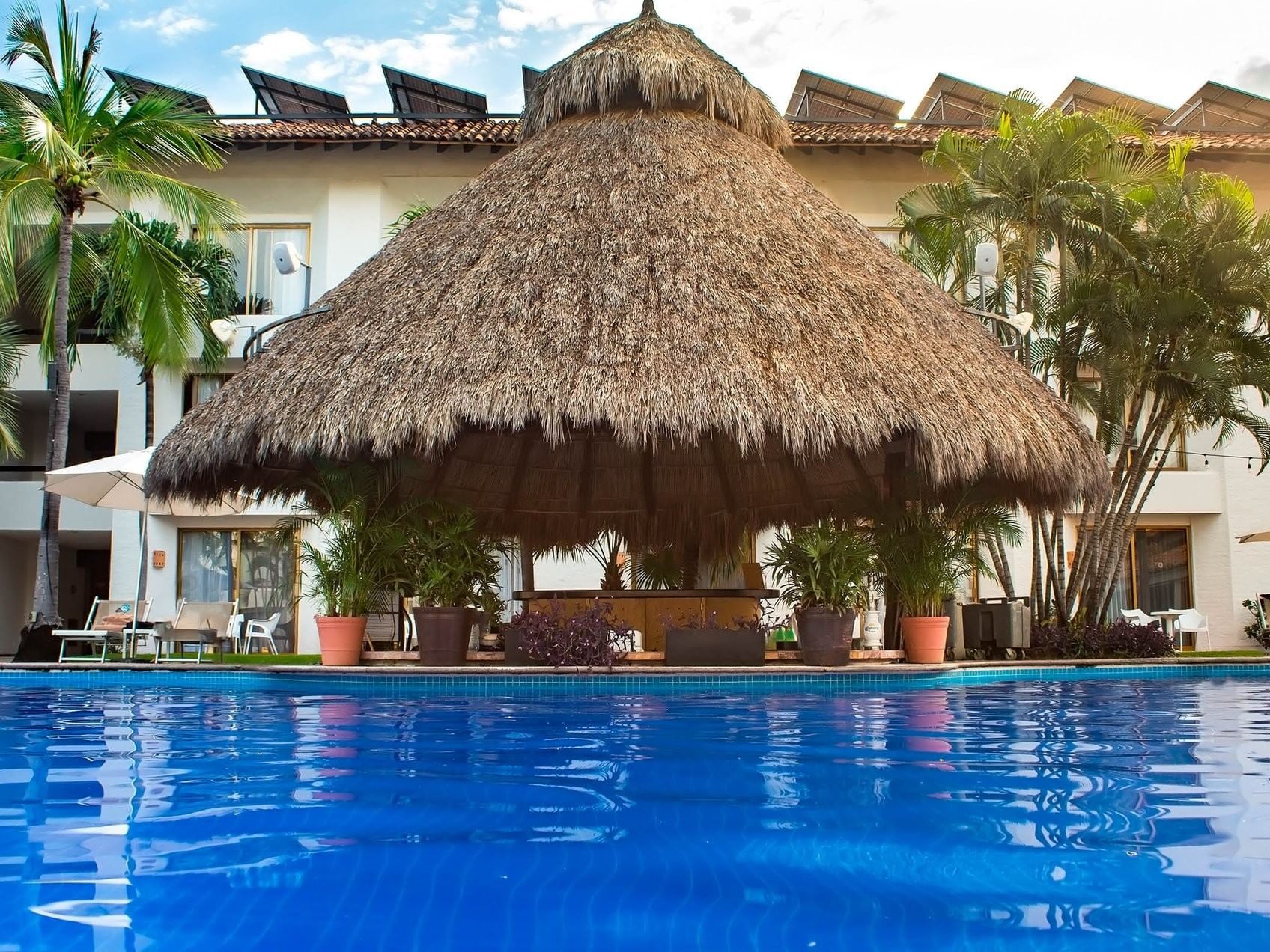 Outside pool area with sunbeds and hut in Gaviotas Aqua Bar at Plaza Pelicanos Club Beach Resort