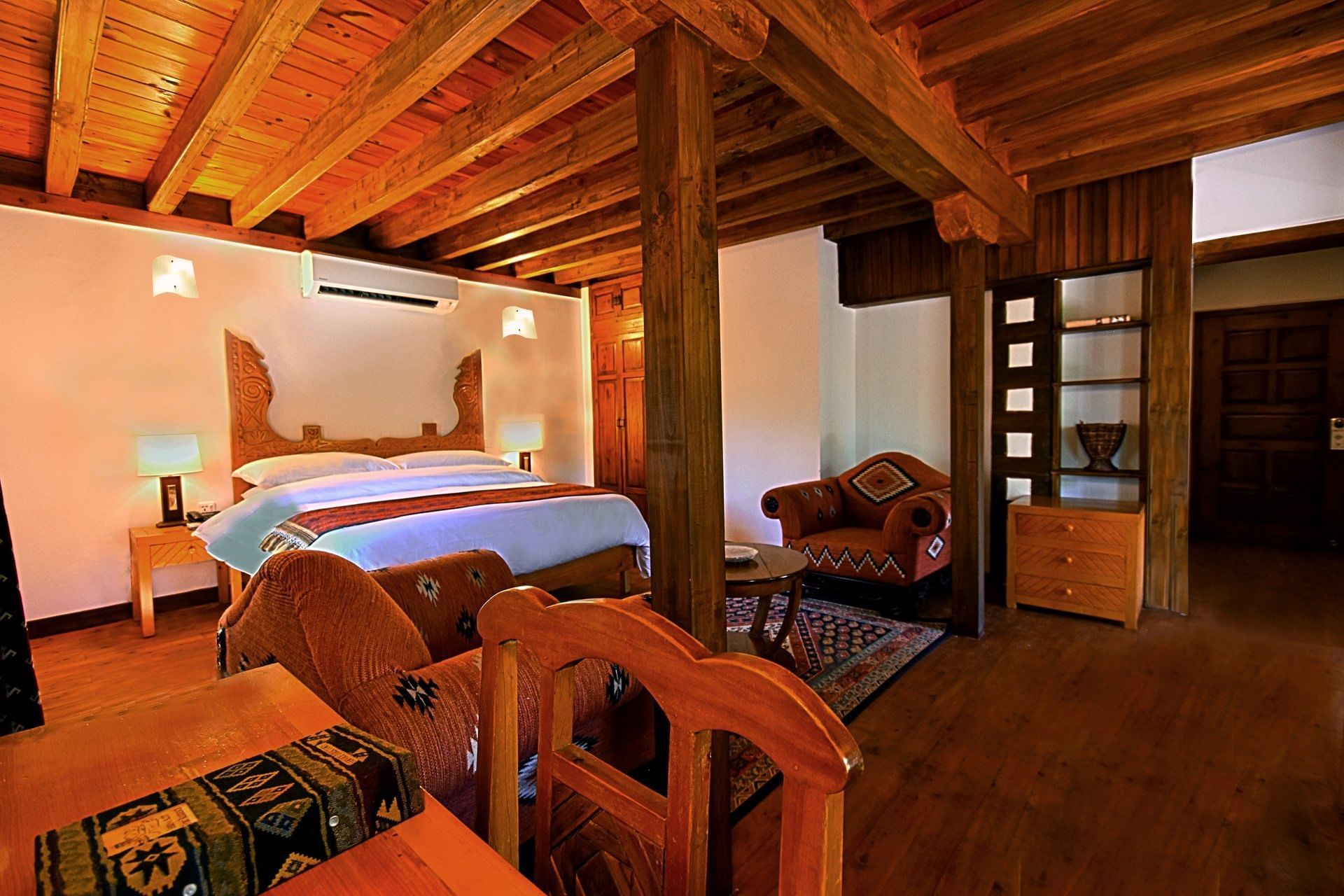 King size bed with study table in a room at Serena Altit Fort