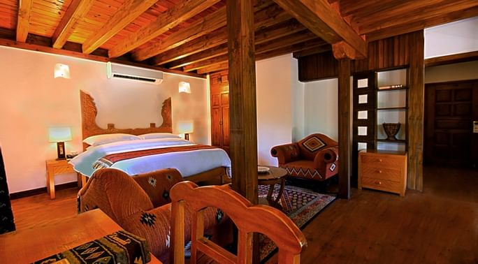 King size bed with study table in a room at Serena Altit Fort
