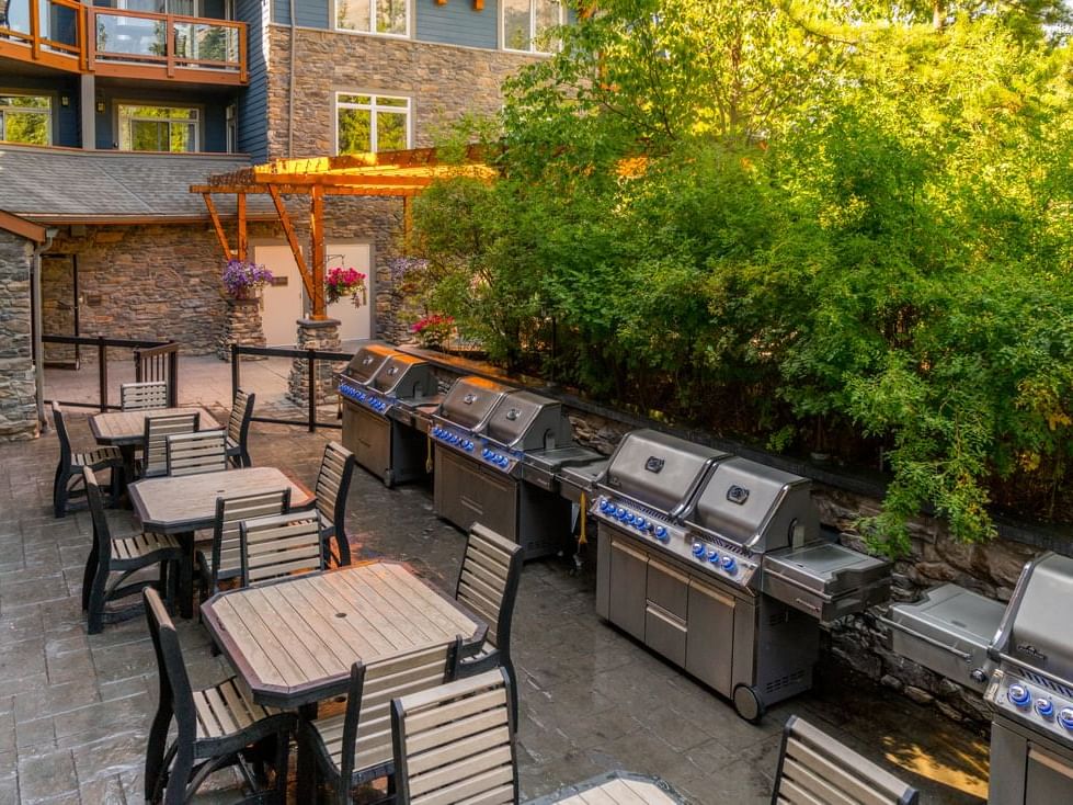 Grills lined by the terrace dining and lounge area at Blackstone Mountain Lodge