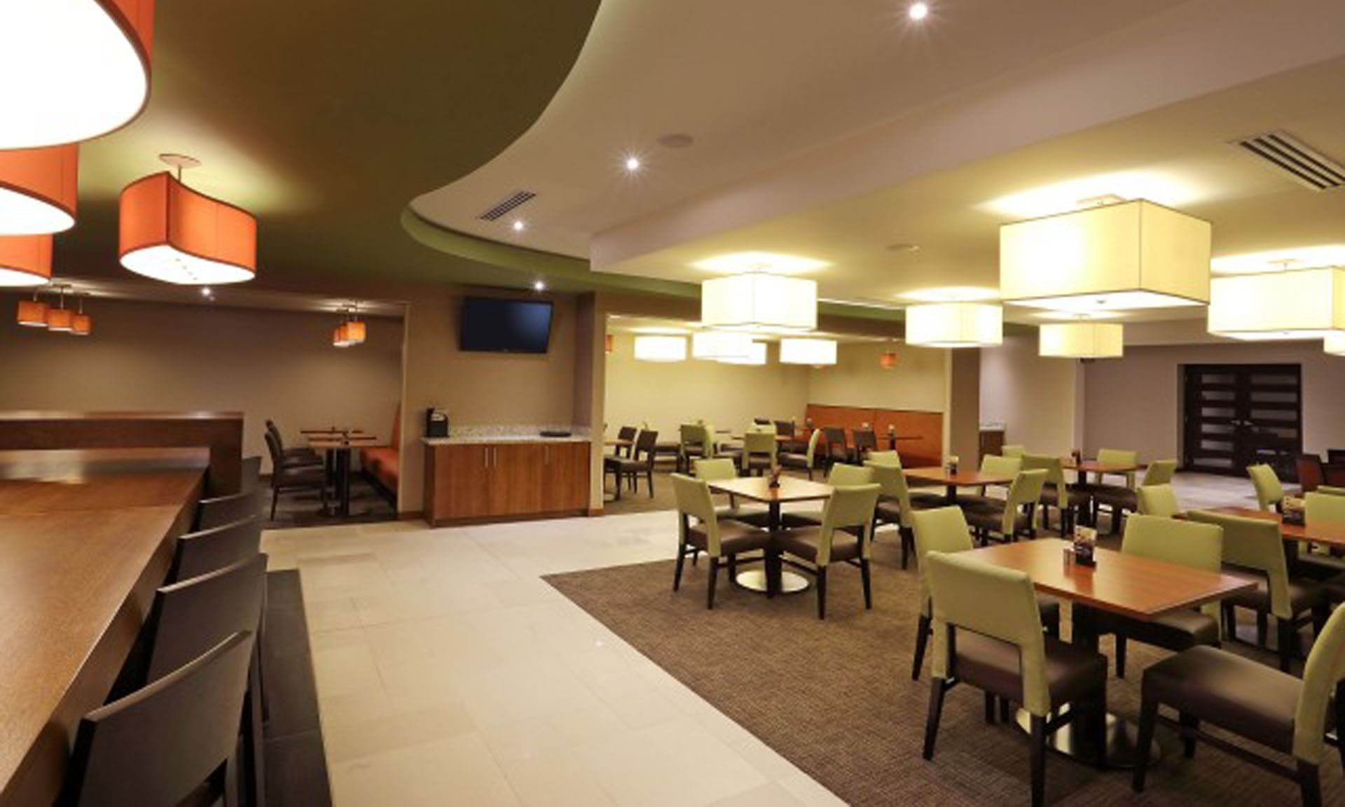 Modern dining area with pendant lighting and a bar counter in MARINN Restaurant at MARlNN Place Financial District