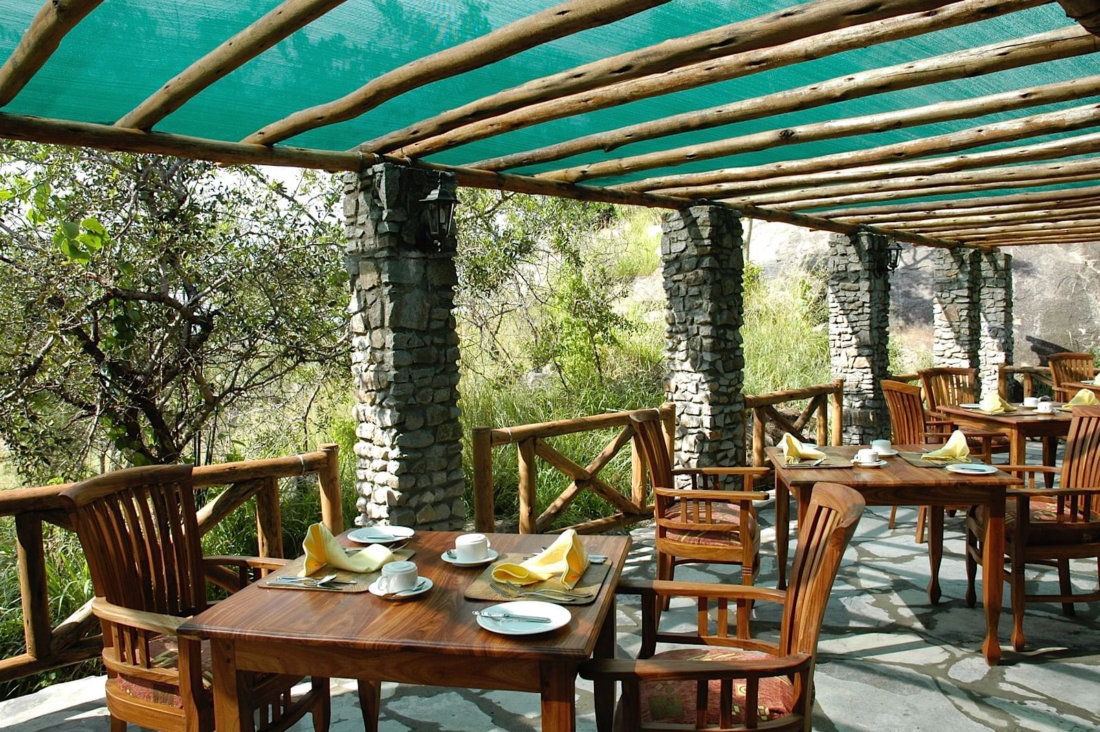 Dining area with arranged tables at Mbuzi Mawe Serena Camp