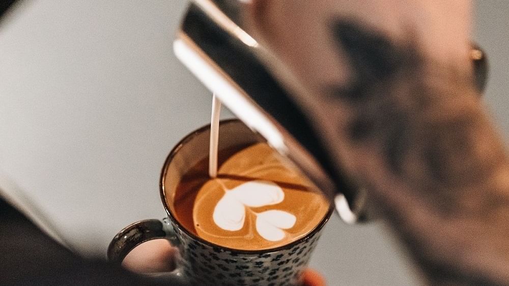 Close-up of pouring latte art in Craft Table Artisan Café & Bakery at Paramount Hotel Dubai