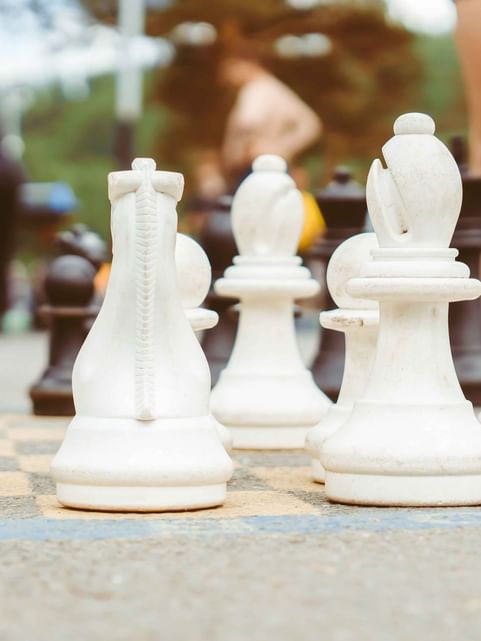 Close-up on chess pieces of the Giant Checkers board outdoors at Cove Pocono Resorts