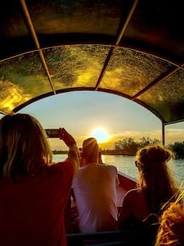 People enjoying a boat tour at sunset near Cove Pocono Resorts