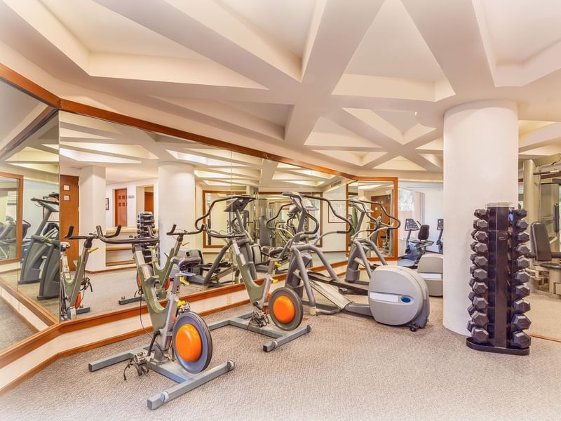 Gym with exercise machines at La Colección Resorts