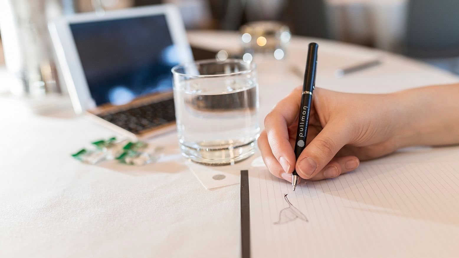 Woman jotting notes in a Meeting at Pullman Olympic Park