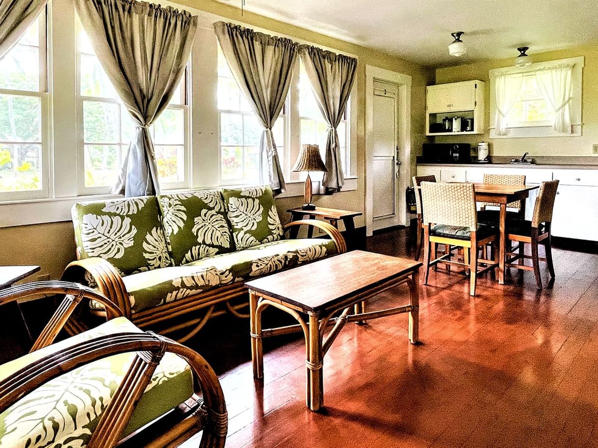 Living room with kitchen appliances, tables, couches, and chairs