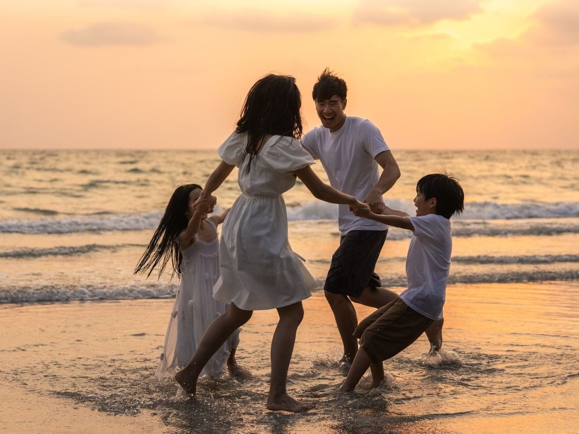 A family Playing Together near sea at The Danna Langkawi Hotel