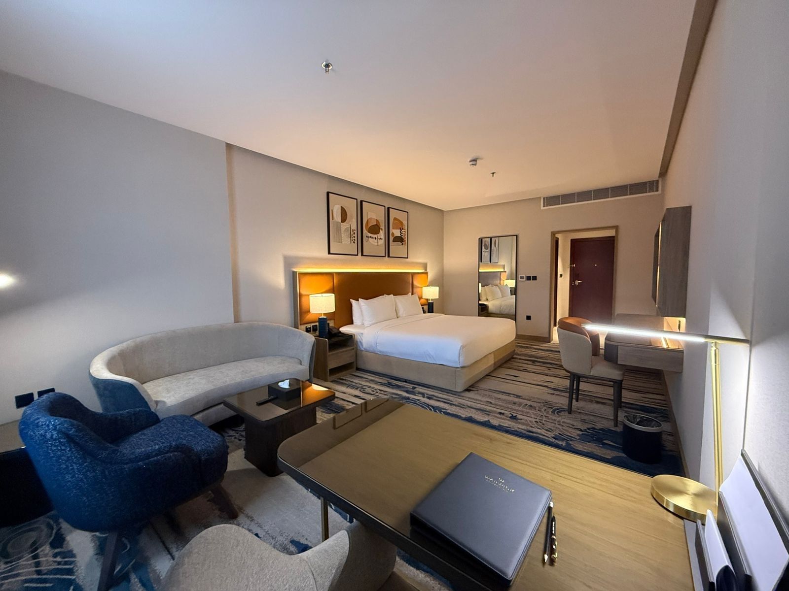 Bed beside the couch and work desks in Superior Room at Warwick Jeddah Hotel & Spa