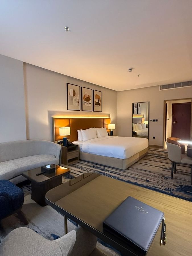 Bed beside the couch and work desks in Superior Room at Warwick Jeddah Hotel & Spa
