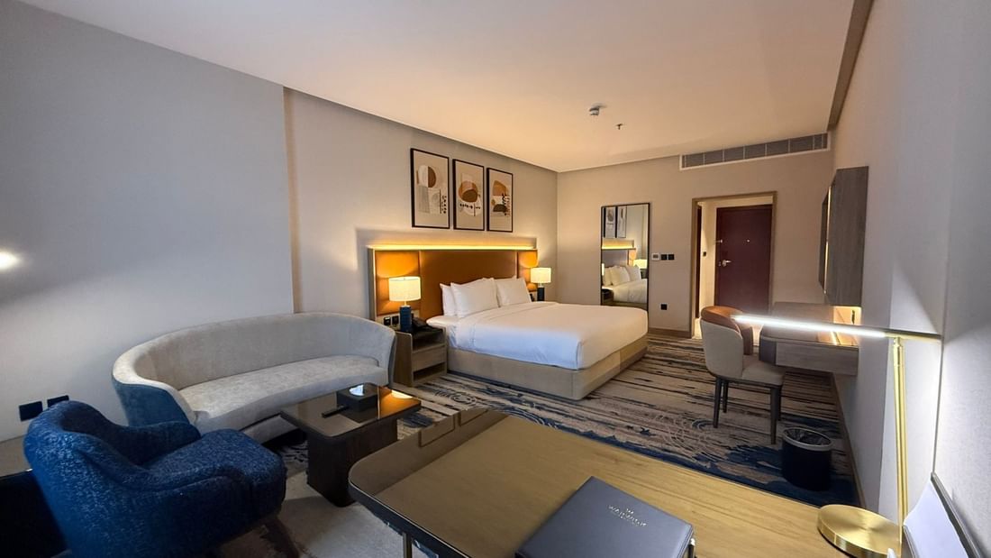 Bed beside the couch and work desks in Premium Club Room at Warwick Jeddah Hotel & Spa