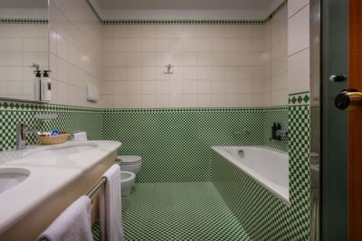 Bathroom vanity with towels and bathtub in Executive Suite at  Hotel Crivi's in Milan