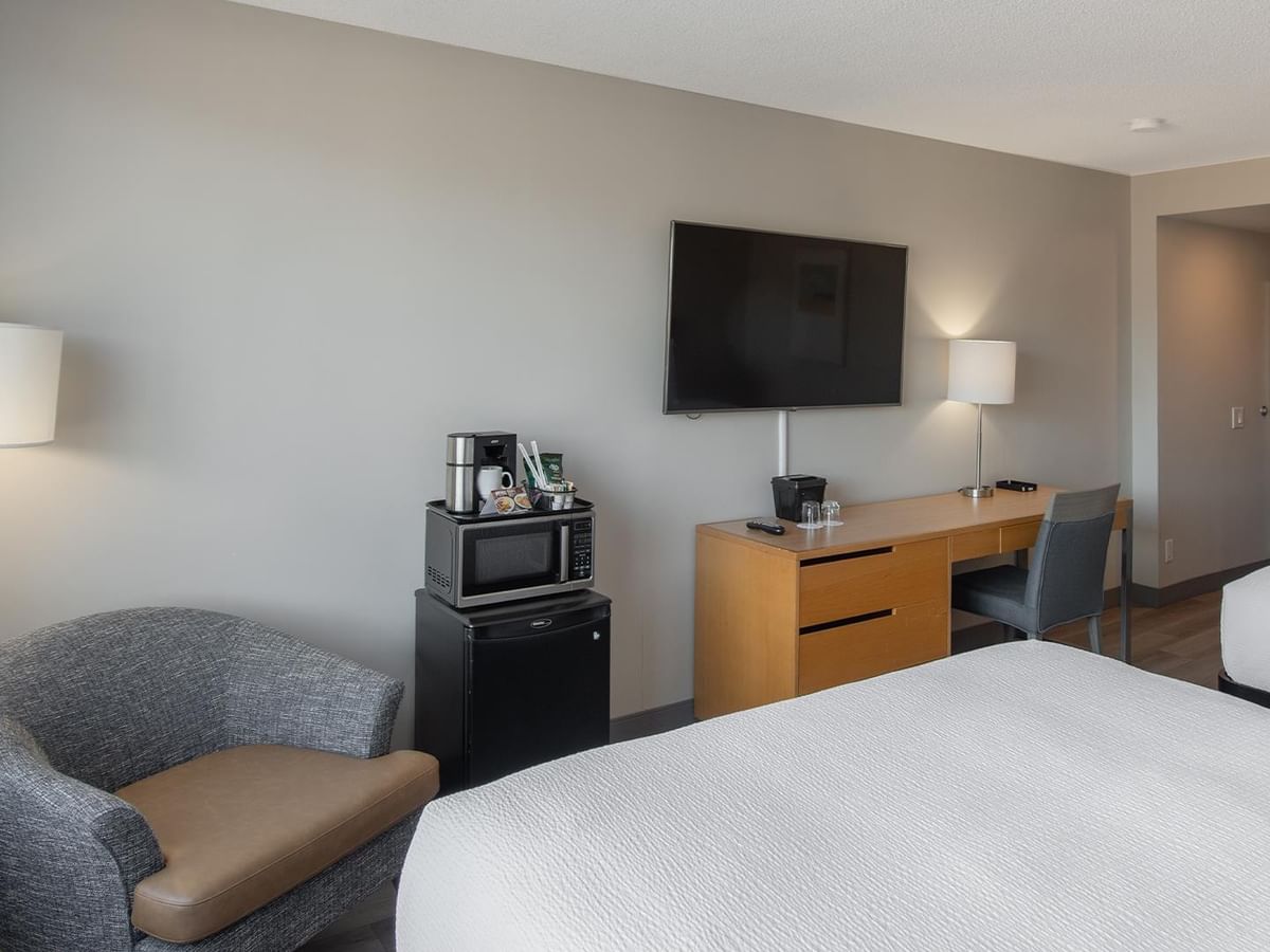 Hotel room with two queen beds, work desk, TV, mini fridge and microwave