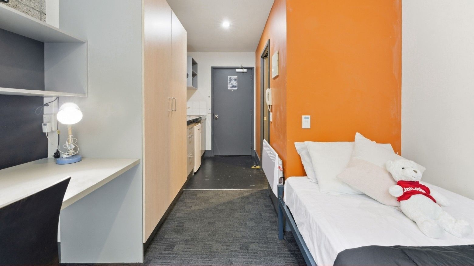 A single room with a bed and desk at Student Living Auckland - Beach.