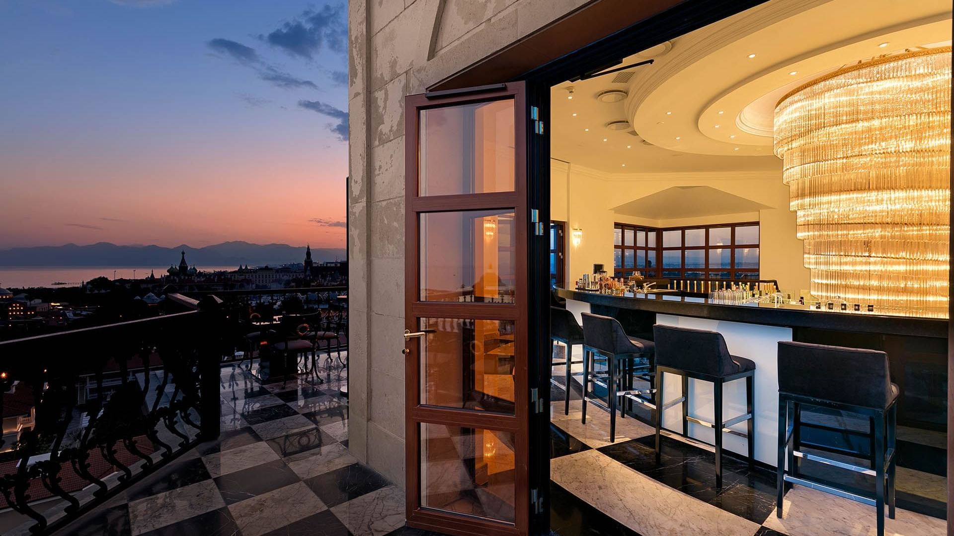 Bar counter area with high stools by the balcony in Tower Roof Bar at Titanic Mardan Palace