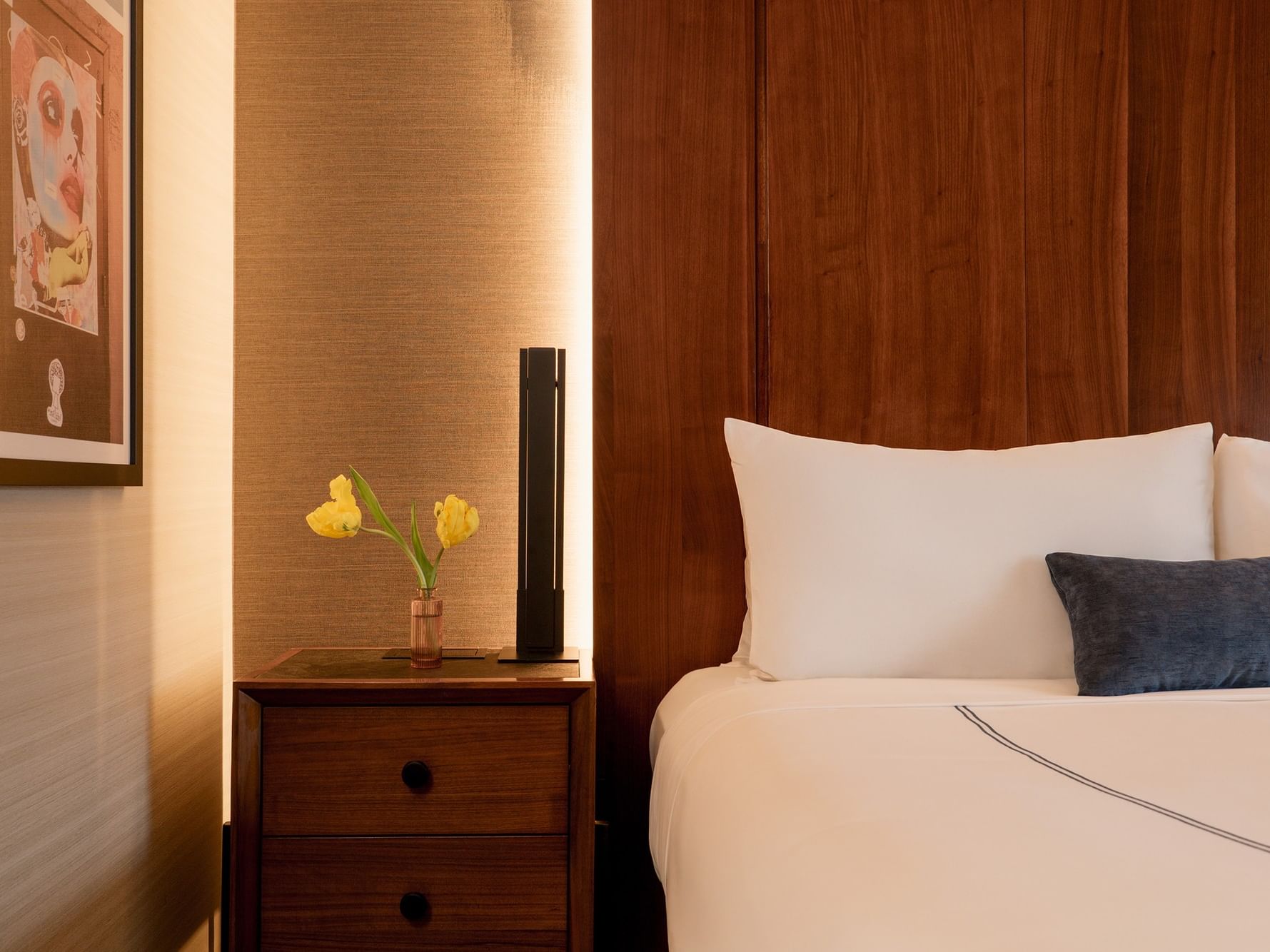 Cozy Deluxe Room with modern decor and wooden furniture at Gansevoort Meatpacking NYC in New York.