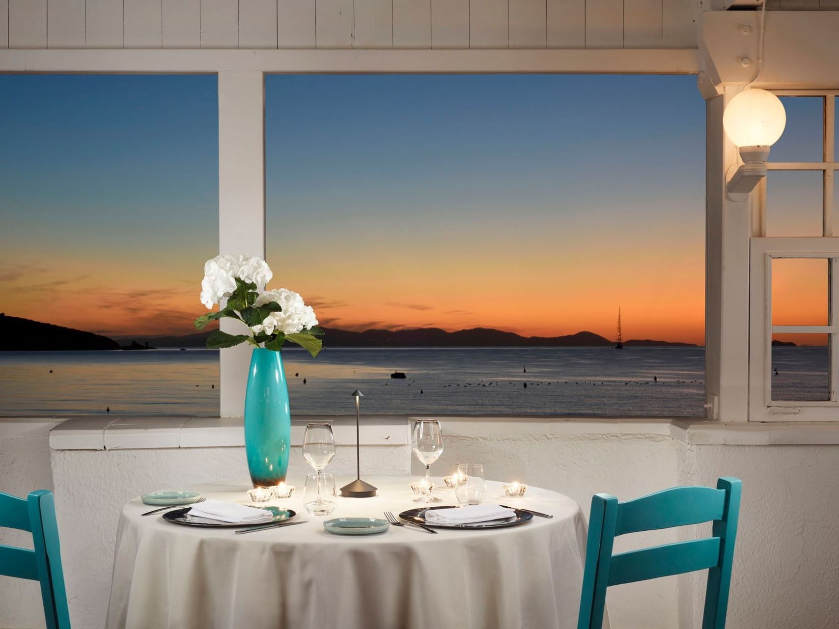 Dinner table arranged in Beach Club at Golf Hotel Punta Ala