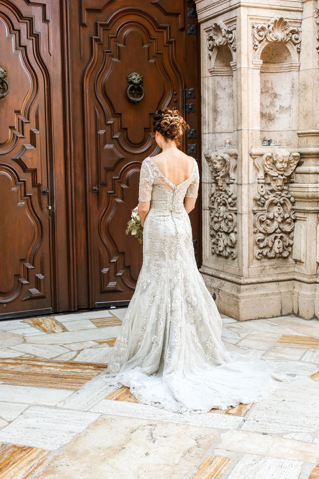 Bride facing the entrance of chapel at Mission Inn Riverside