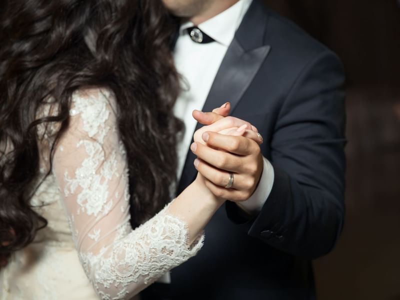 Bride & groom holding hands together at Fullerton Group