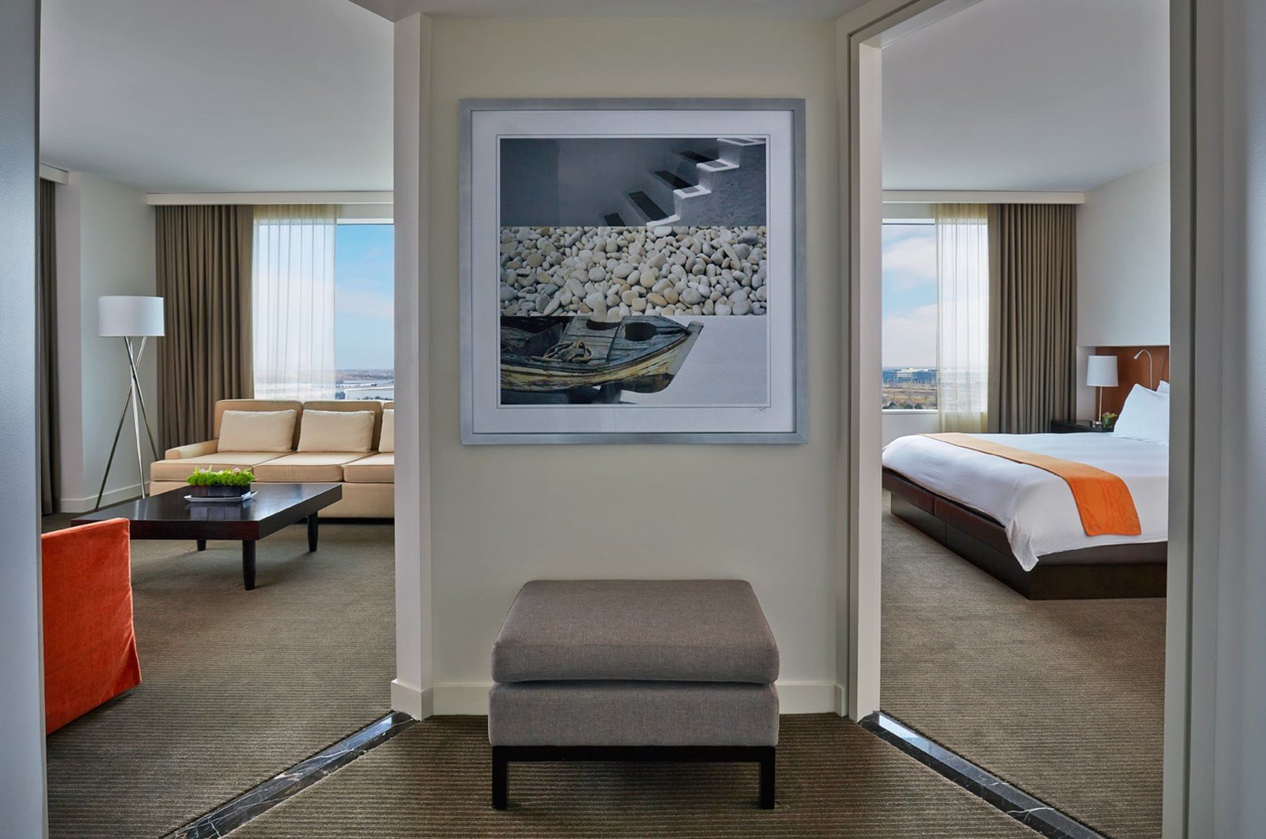 a hotel room with a bedroom and living area