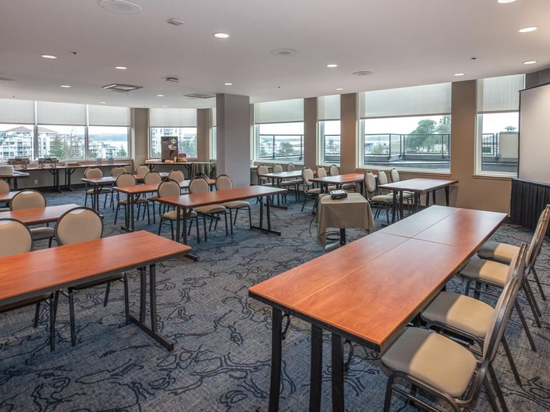 A large conference room with tables and chairs at Coast Bastion Hotel.