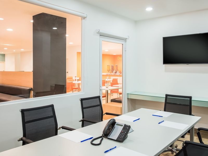 Well-arranged standard meeting room with a TV at One Hotels