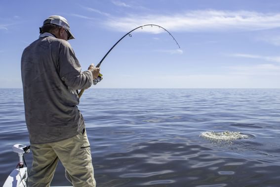 A man fishing in the sea at Sunseeker Resort