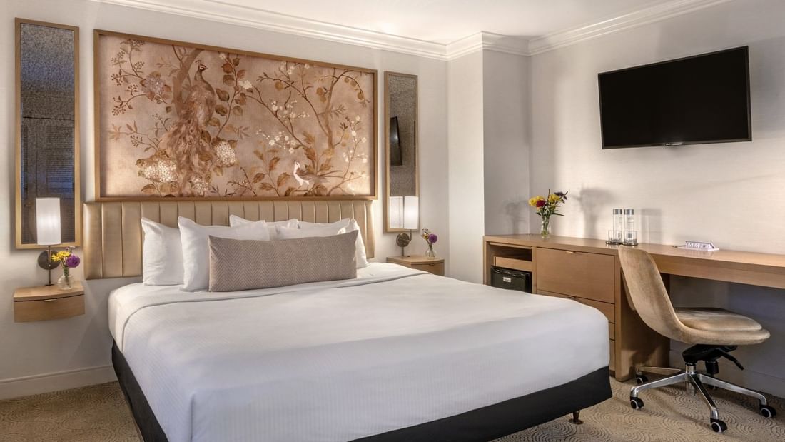 Bed with work desk under hanging TV in Accessible Standard Room at Warwick Allerton Chicago