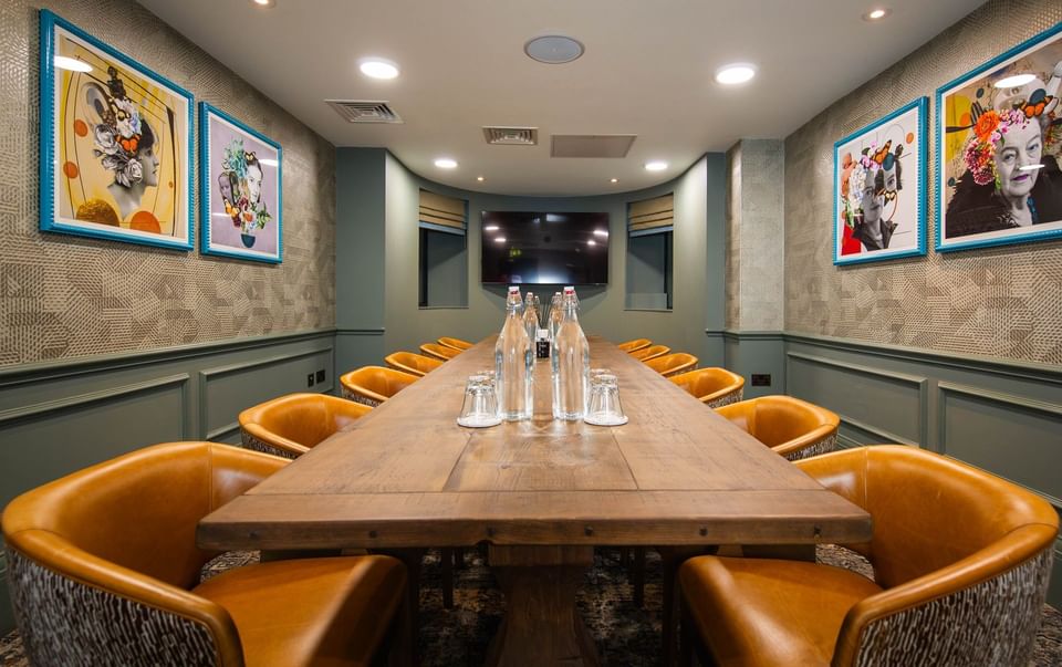 Executive Barbara Hepworth room at The Met Hotel Leeds, England, with a long wood table, leather chairs, and pop art pieces