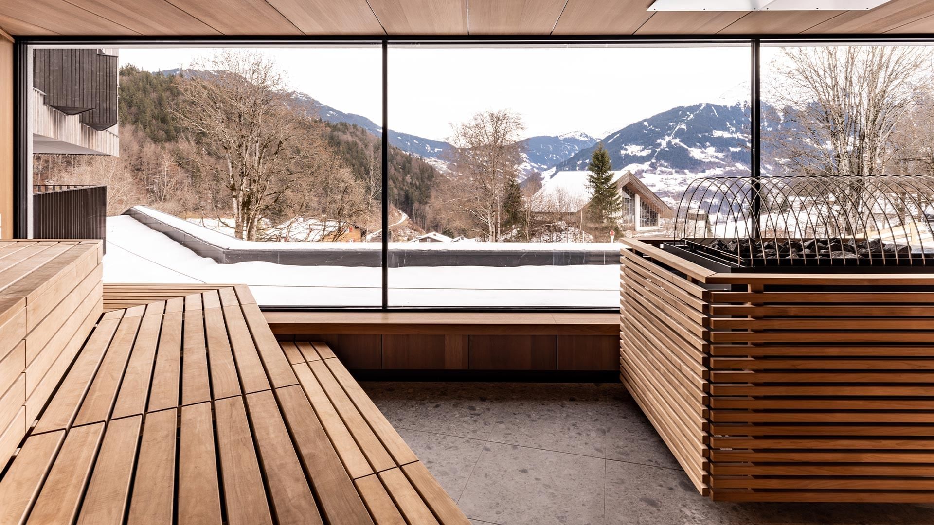 Wooden Sauna with seating overlooking mountains at Falkensteiner Hotel Montafon