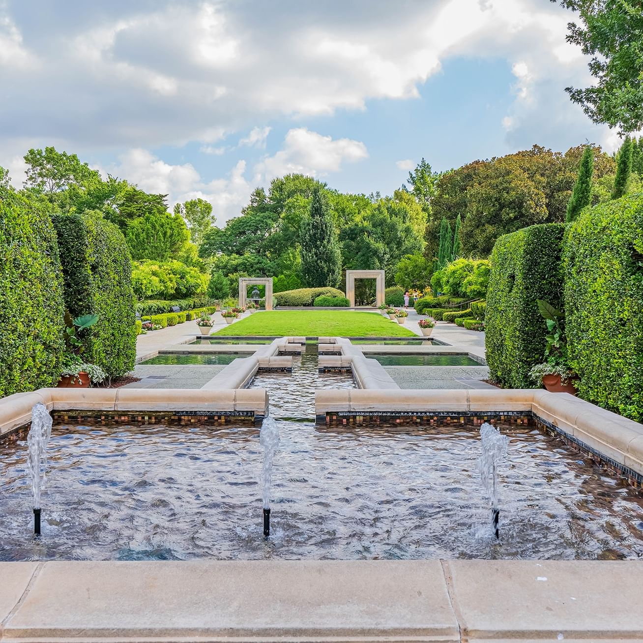 A serene water feature surrounded by greenery at Dallas Arboretum and Botanical Garden.